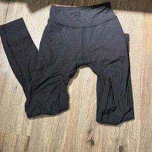 Lululemon black high rise joggers with wash wear throughout and pulling in legs